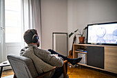 Man with headset playing video game