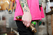 Plumber's hands holding pipe