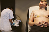 Patient after mastectomy lying in doctor's office