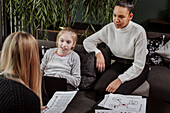 Women teaching girl at home