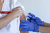 Female doctor receiving covid-19 vaccine