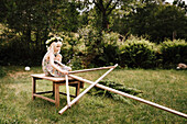 Girl in garden preparing maypole in garden