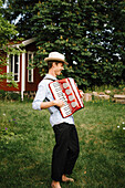 Man playing accordion in garden