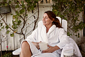 Woman having coffee in garden