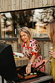 Woman putting vegetables on grill
