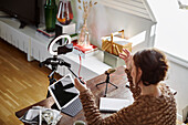 Woman sitting at desk and recording video