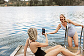 Happy female friends at lake