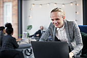 Man in modern office using laptop