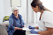 Nurse with elderly woman at home