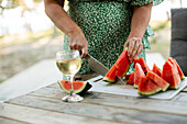 Woman cutting watermelon