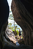 Man standing in cave at seaside