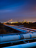 Pipeline outside city at dusk