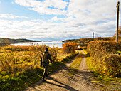 Hiker walking in autumn landscape