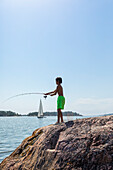 Boy fishing at lake