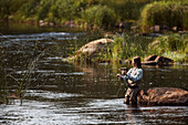 Woman fishing in lake