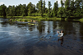 Woman fishing in river