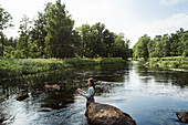 Woman fishing in river