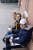 Portrait of school friends sitting on bench