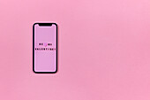 Smartphone with love message on pink background