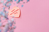 Flowers and love message on pink background