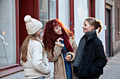 Young female friends talking outdoors