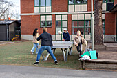 Group of teenagers playing table ball game