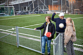 Friends standing on school soccer field