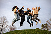 Low angle view of teenage friends jumping