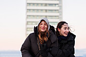 Smiling female couple in winter clothing