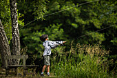 View of boy fishing