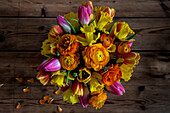 Colorful bouquet on wooden surface