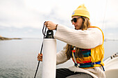 Woman holding fender on boat