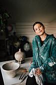Portrait of female potter in workshop