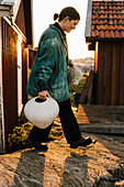 Young woman carrying handmade vases