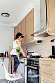 Girl preparing food in kitchen