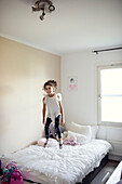 Girl jumping on bed