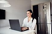 Woman at table using laptop