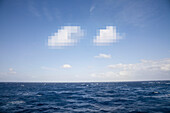 Pixelated clouds in blue sky and sea
