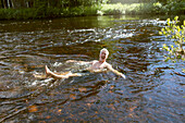 Man swimming in river