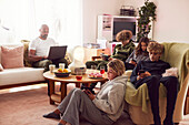 Family with children using electronic devices at home