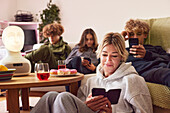 Mother with children using electronic devices at home