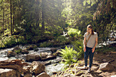 Young man at forest river