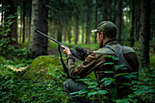 Hunter waiting in forest