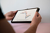 Hand holding digital tablet