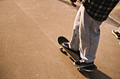 Legs of teenage girl skateboarding