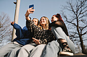 Teenage girls taking selfie with smart phone