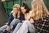 Teenage girls using smart phone