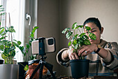 Woman vlogging about potted plants