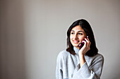 Young woman talking on phone