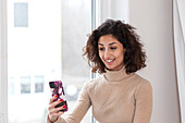 Young woman having video call on smart phone